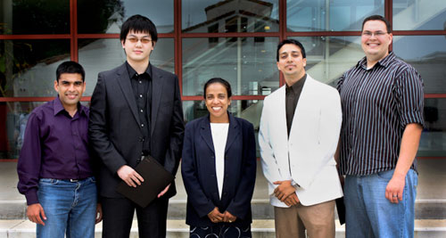 An Amgen Representative Presenting Scholarships to Four Receipents